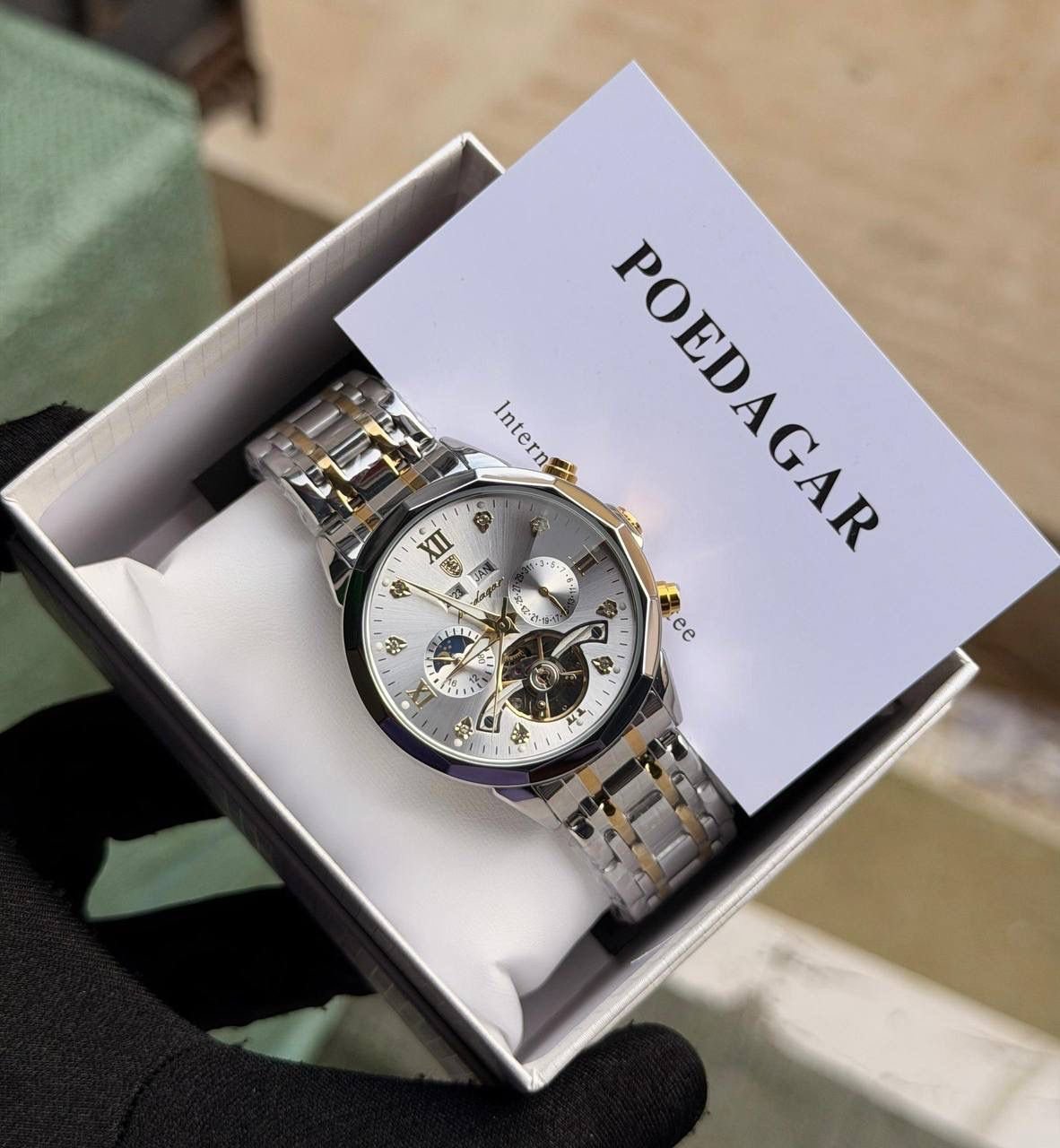 Poedagar automatic chain watch featuring stainless steel case, sapphire glass, water‑resistant design, and chain bracelet.